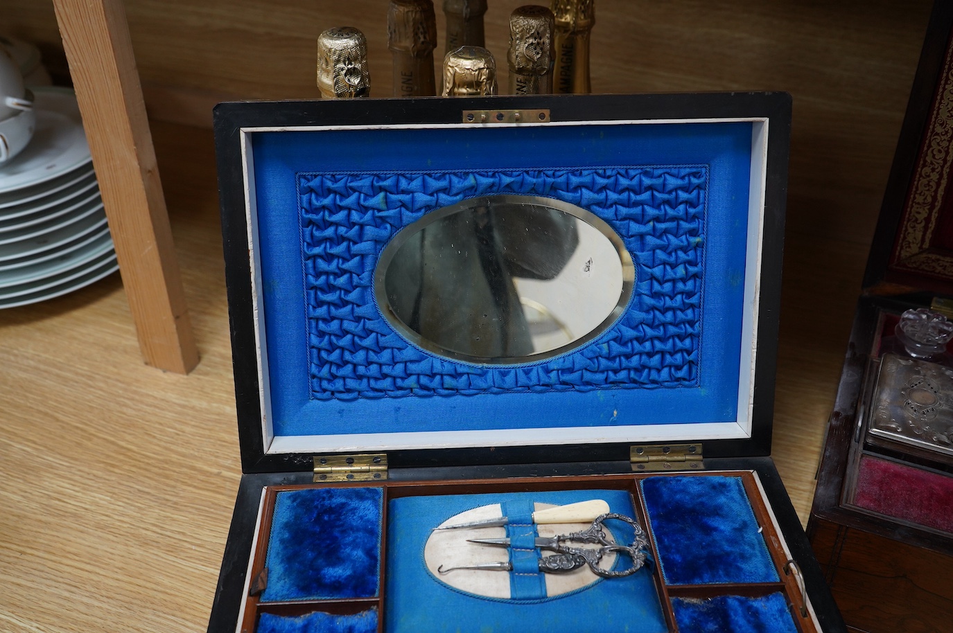 Three 19th century vanity and sewing boxes with fitted interiors to include a mother of pearl inlaid example with glass bottles, jars and mirror, largest 35cm wide. Condition - fair, some losses